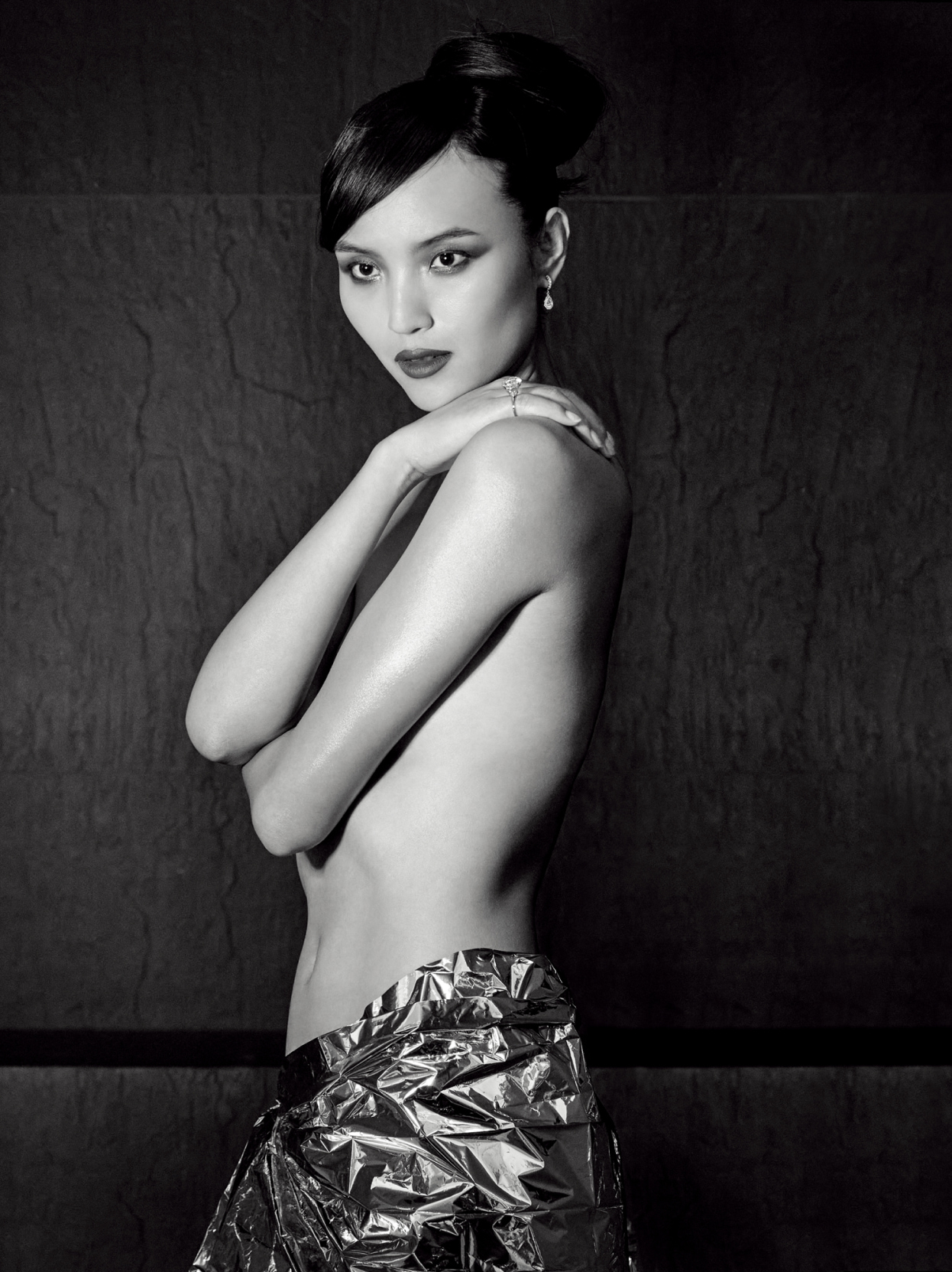 Topless model with arms crossed